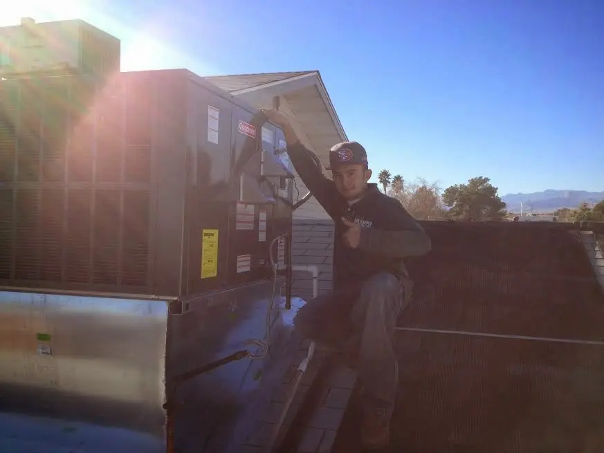HVAC technician performing Boiler Repair on a rooftop unit in New Brighton